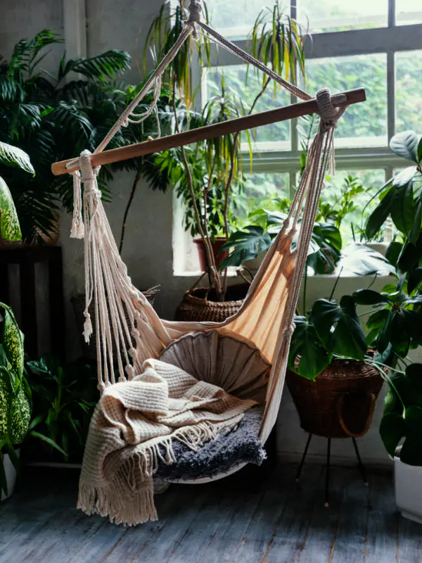 A lushly decorated Townsville home library with floor-to-ceiling plants, hanging vines, and diverse botanical textures